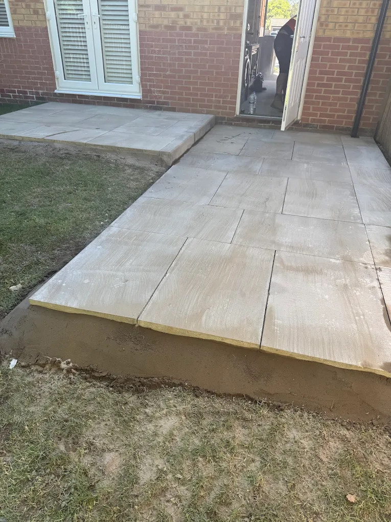 Sandstone patio laid to a high standard against a brick property