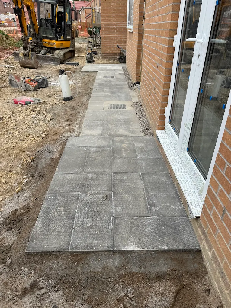 Grey paving installation along a new-build property by Tyne & Wear Groundworks LTD